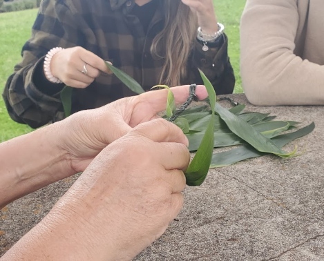 people weaving Lei (a garland or wreath common in Hawaii)
